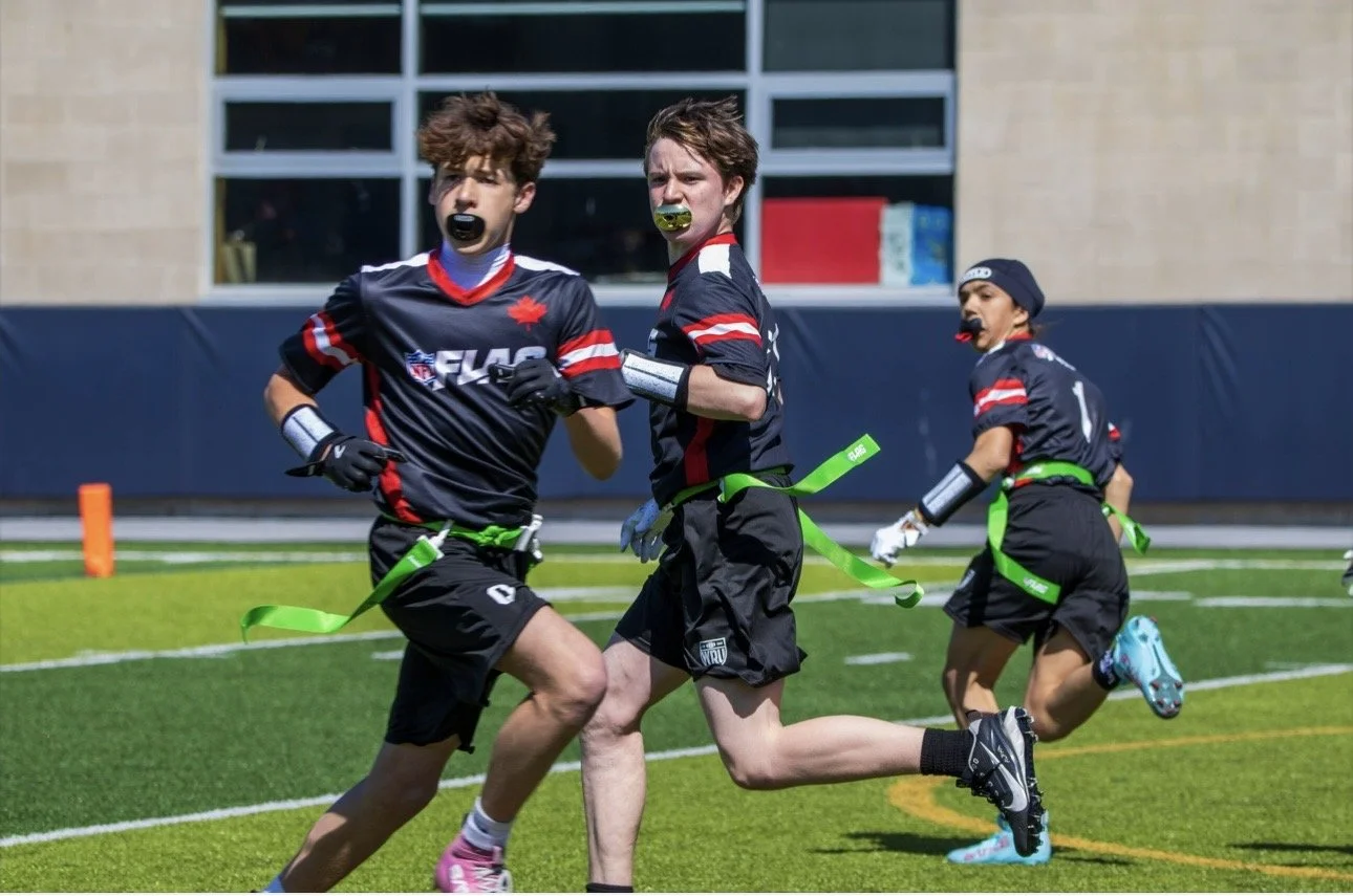 Three WRU flag football players running routes on the field