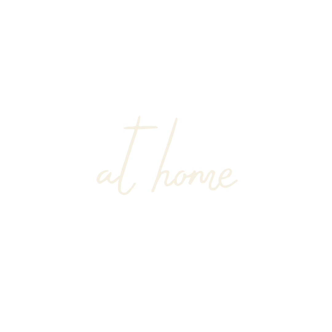 Black background with white handwritten text that says 'at home'.