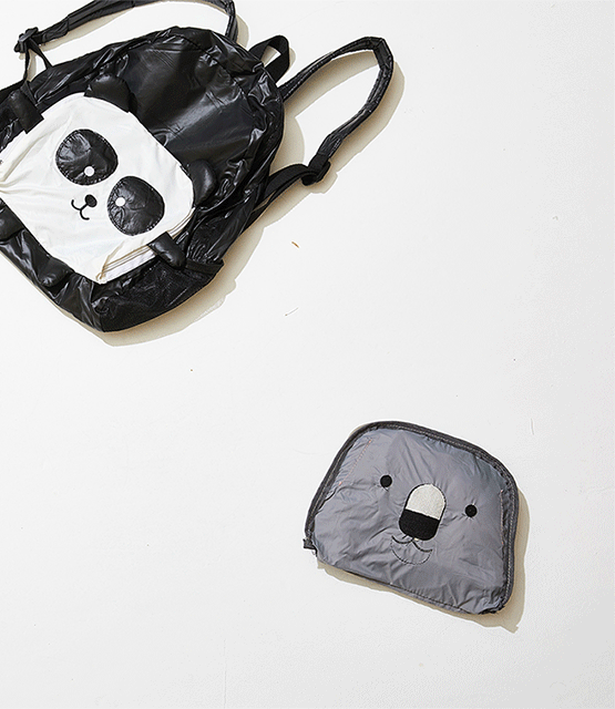 A panda-themed backpack and a koala-themed lunch bag placed on a white surface.