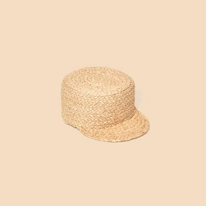 A woven straw hat with a brim, placed against a neutral background.