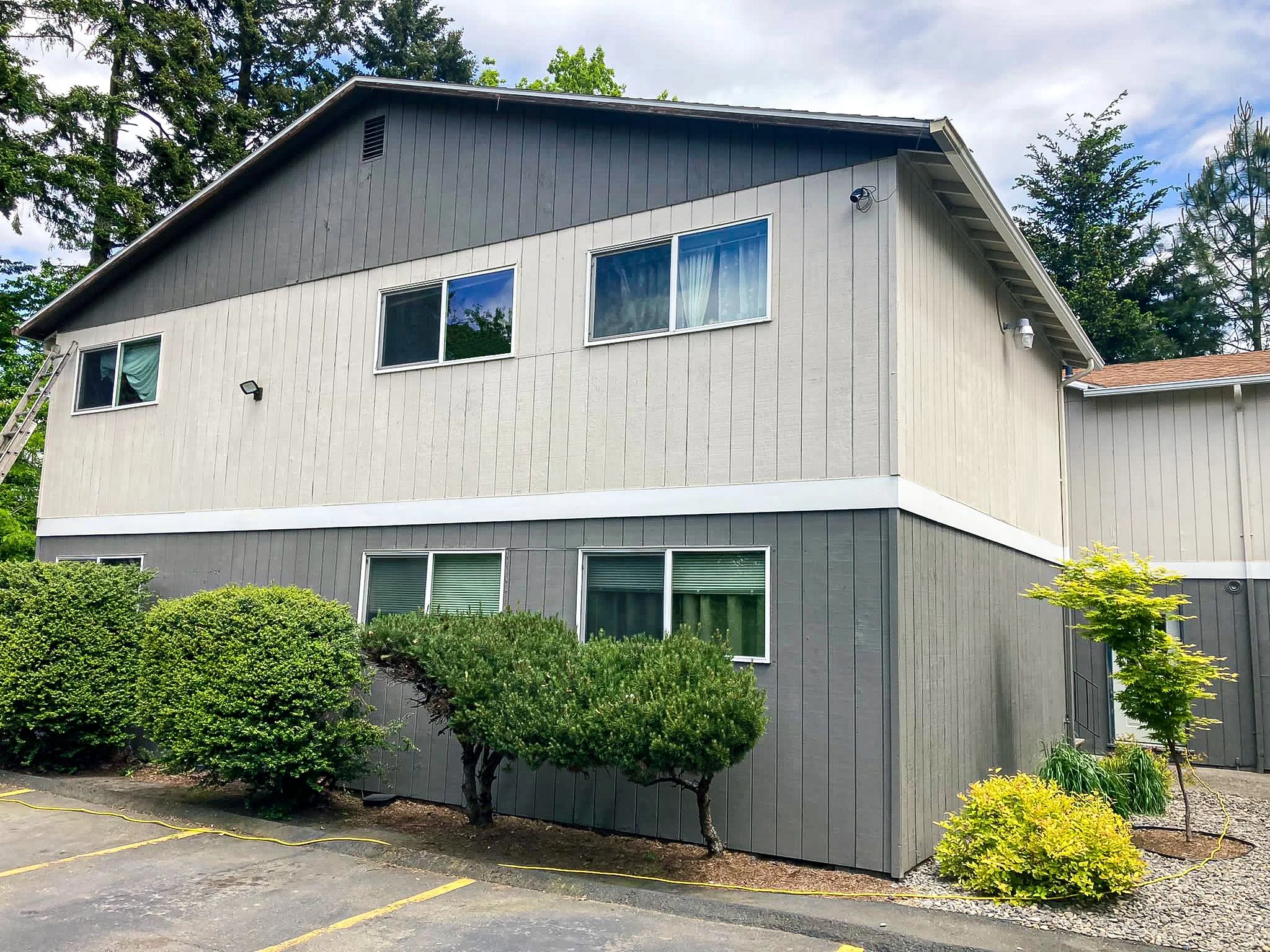 Exterior of a clean apartment building, showcasing the siding.