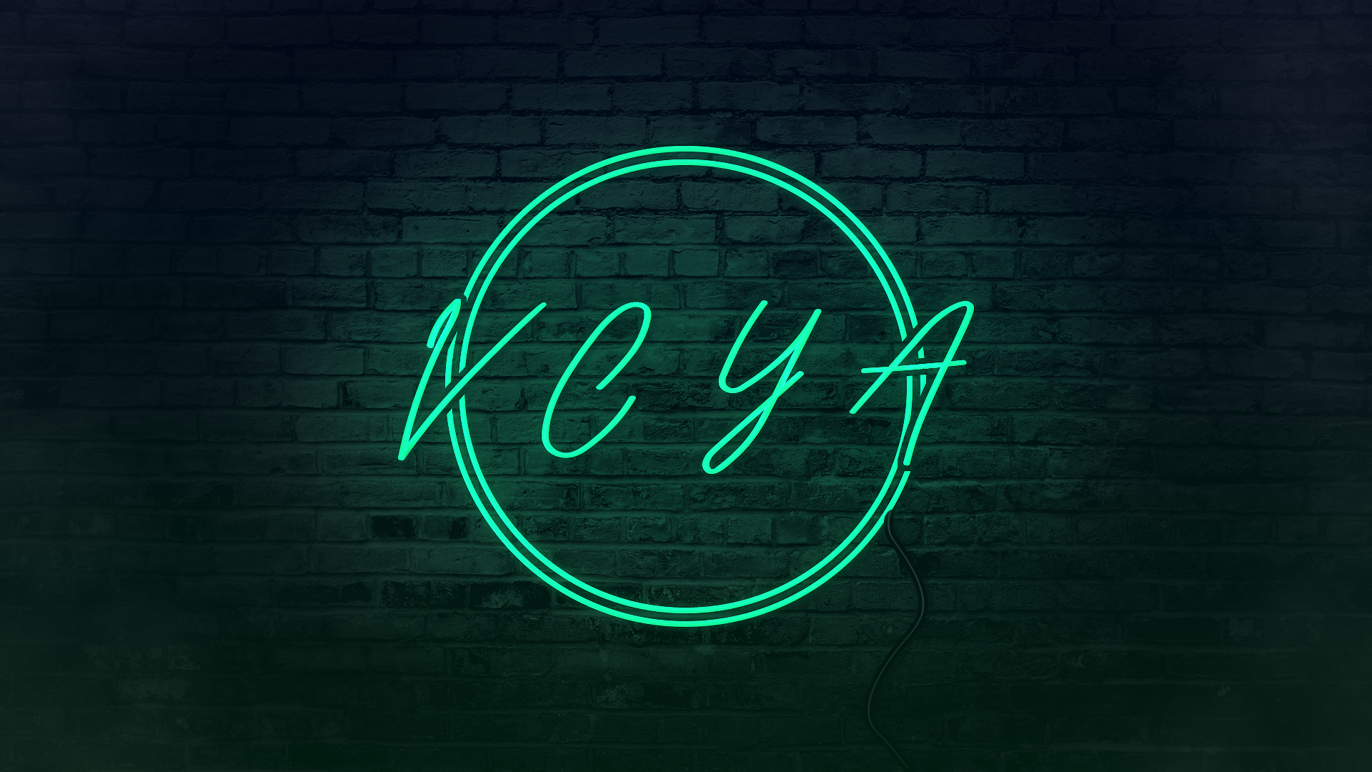 Neon sign reading "KEY" mounted on a brick wall, illuminated in blue-green color.