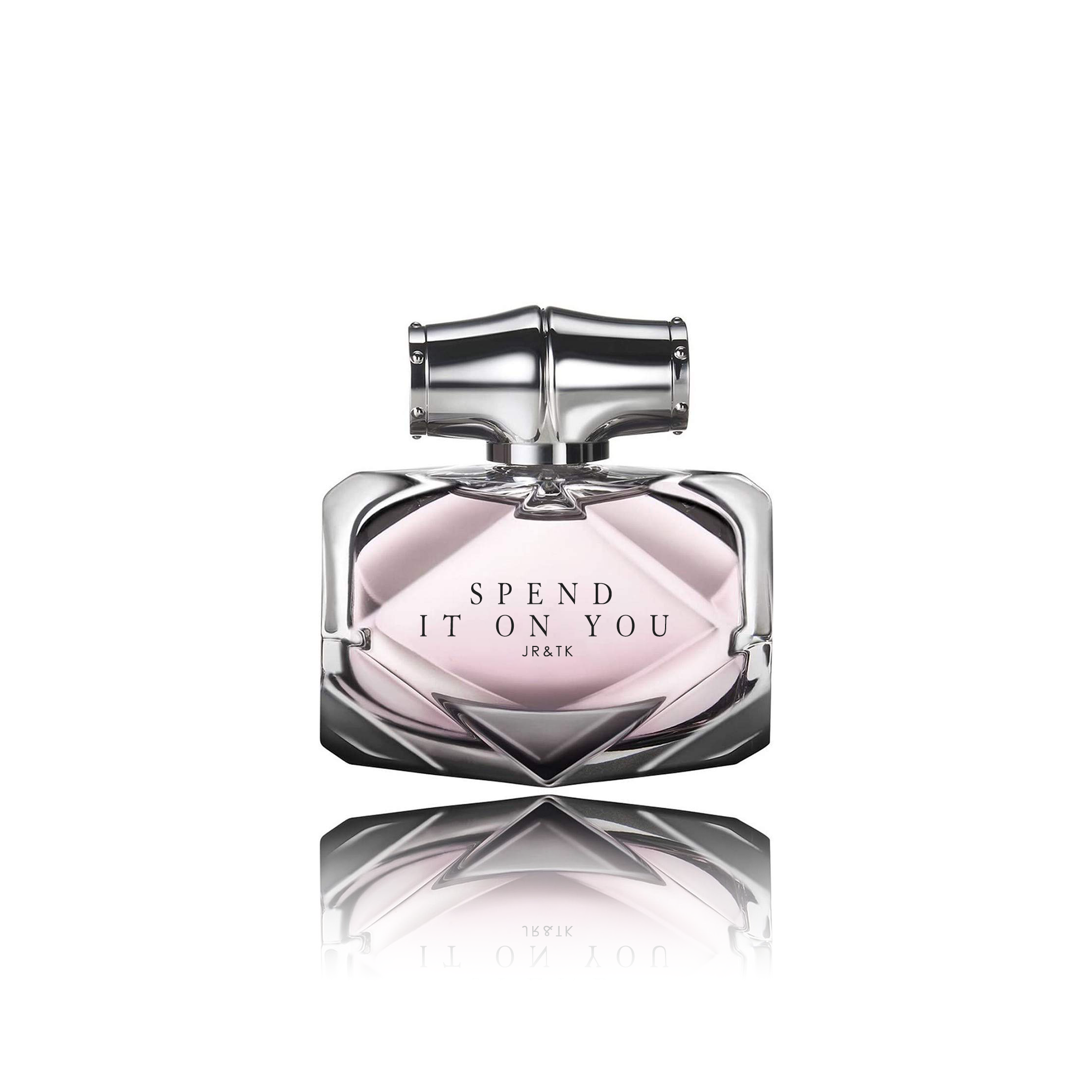 A sleek, silver perfume bottle with a reflective surface, engraved with the text 'SPEND IT ON YOU' and 'JR & TK', set against a white background.