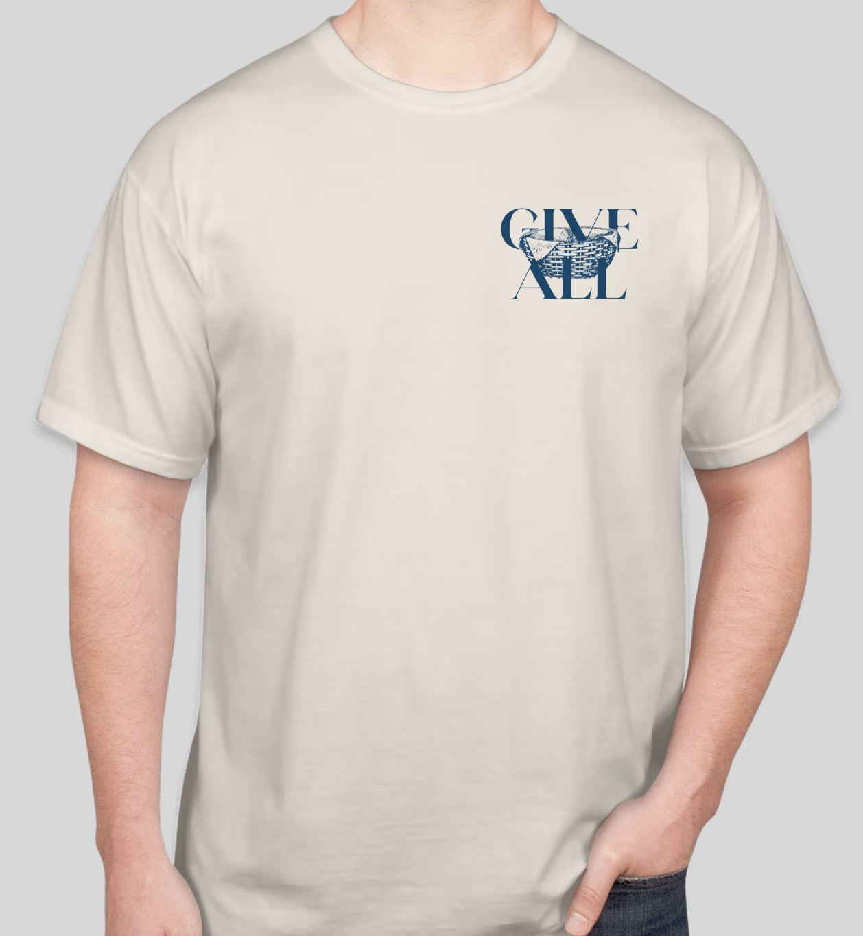 A person wearing a beige T-shirt with a blue graphic design and text that says "GIVE ALL" and a basket illustration.