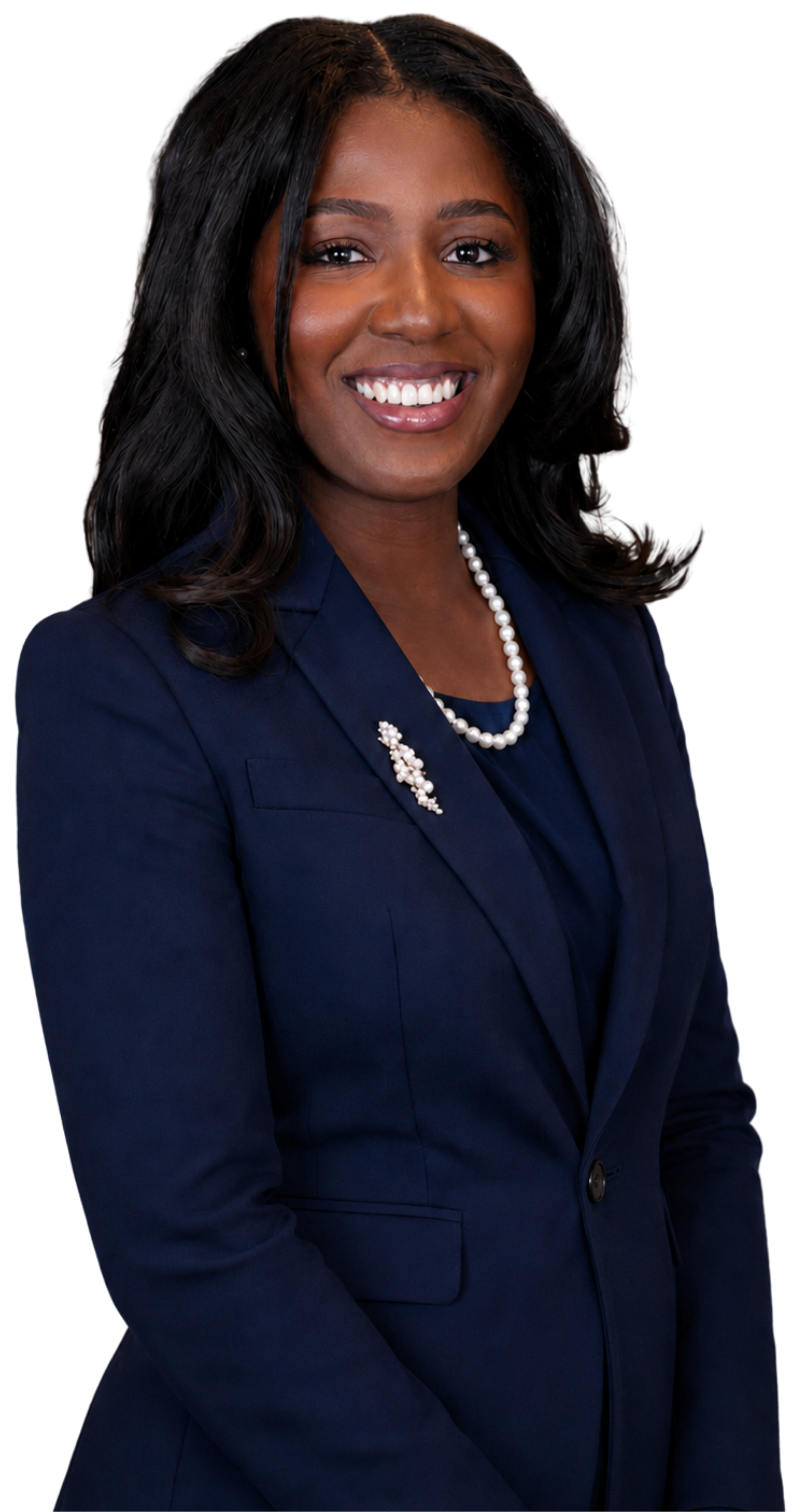 Portrait of an African American woman with long black hair, smiling, dressed in a navy blue blazer, white pearl necklace, and pearl brooch.