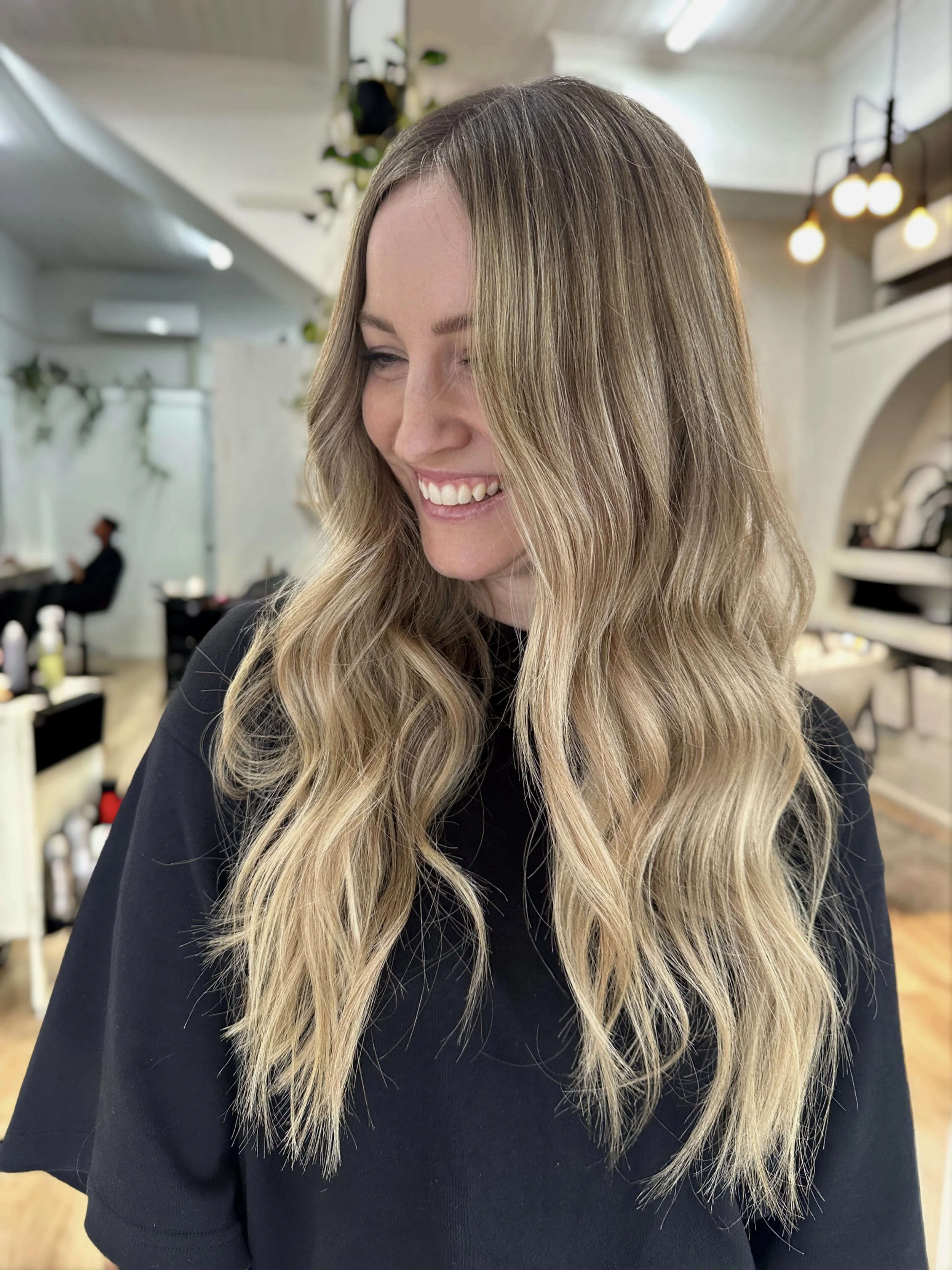 Long dimensional blonde with bright ends and soft natural depth by Kara's Hair Chair, serving Newcastle and Lake Macquarie.