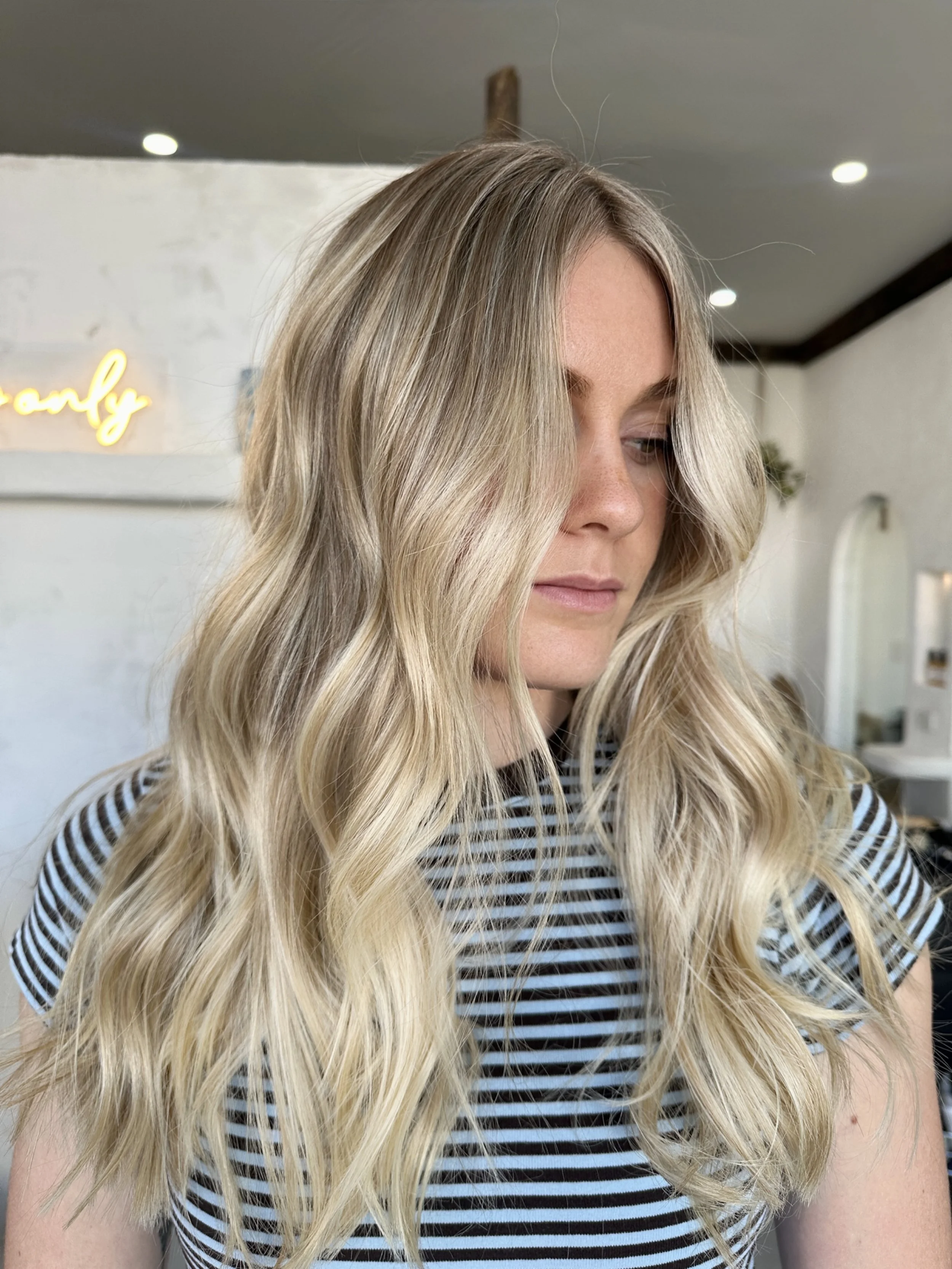 Lived in blonde with a soft root blend and bright dimensional ends by Kara's Hair Chair in Belmont NSW.