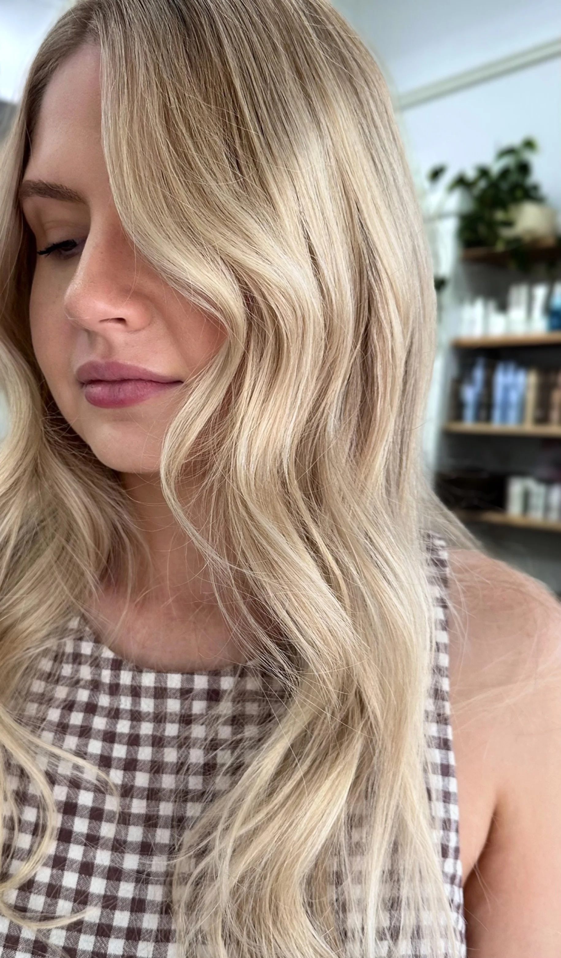 Creamy bright blonde with soft waves and a seamless finish by Kara's Hair Chair, hair colourist in Belmont NSW.