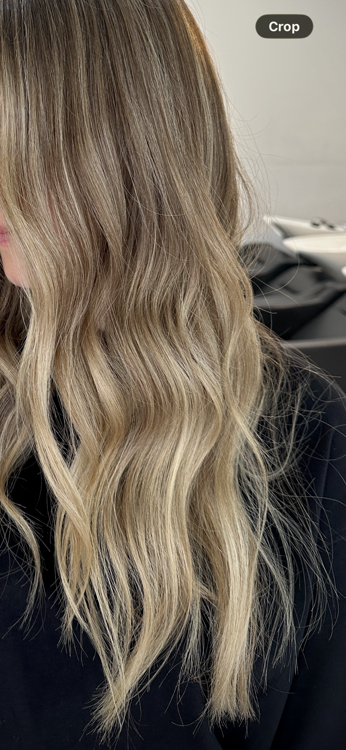 Close up side view of a dimensional bronde lived in colour by Kara's Hair Chair in Belmont NSW. Showing long healthy hair created by a colour expert.