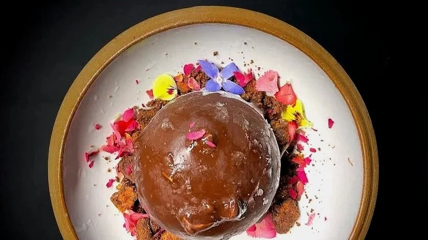 tartufo composed of concentric circles of creme brulee ice cream and bergamot blood orange sorbet