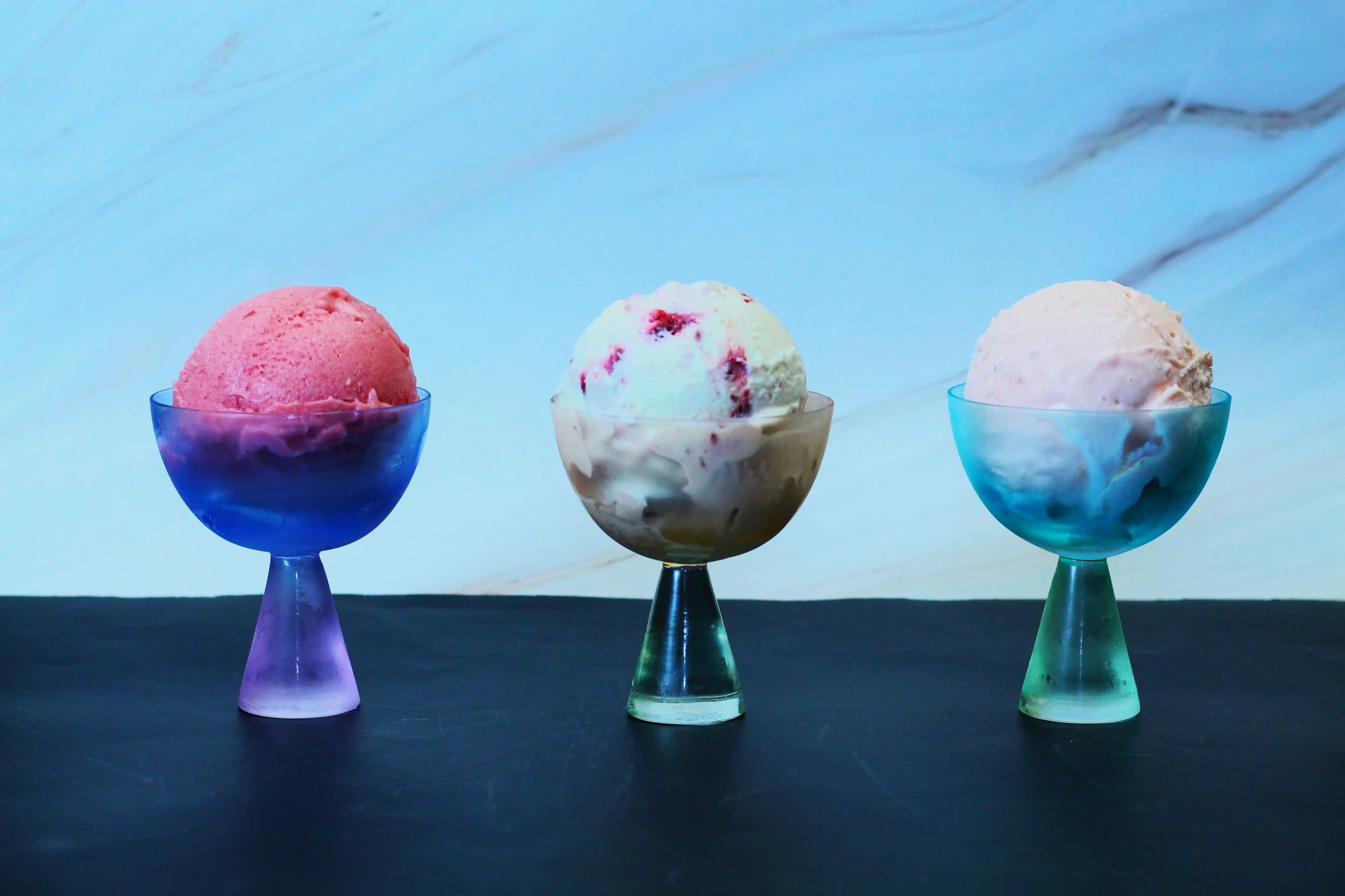 trio of seasonal ice cream/ sorbet: plum anise hyssop swirl, rhubarb elderflower sorbet, basque cheesecake custard 