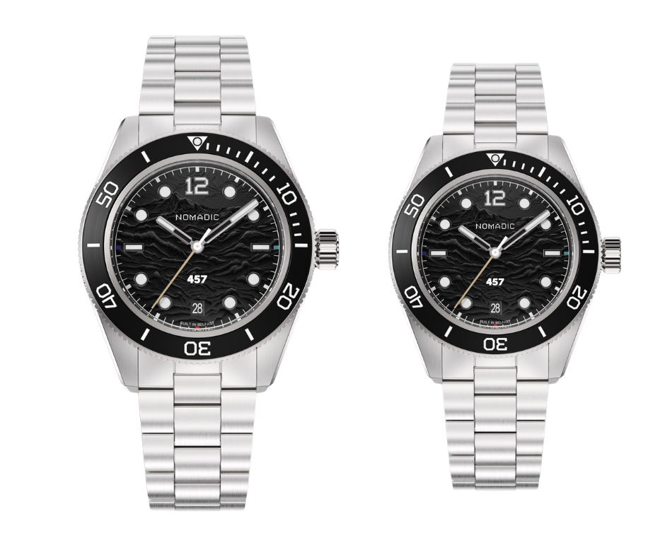 Two silver wristwatches with black dials, black rotating bezels, and metal link bands, positioned side by side against a black background.