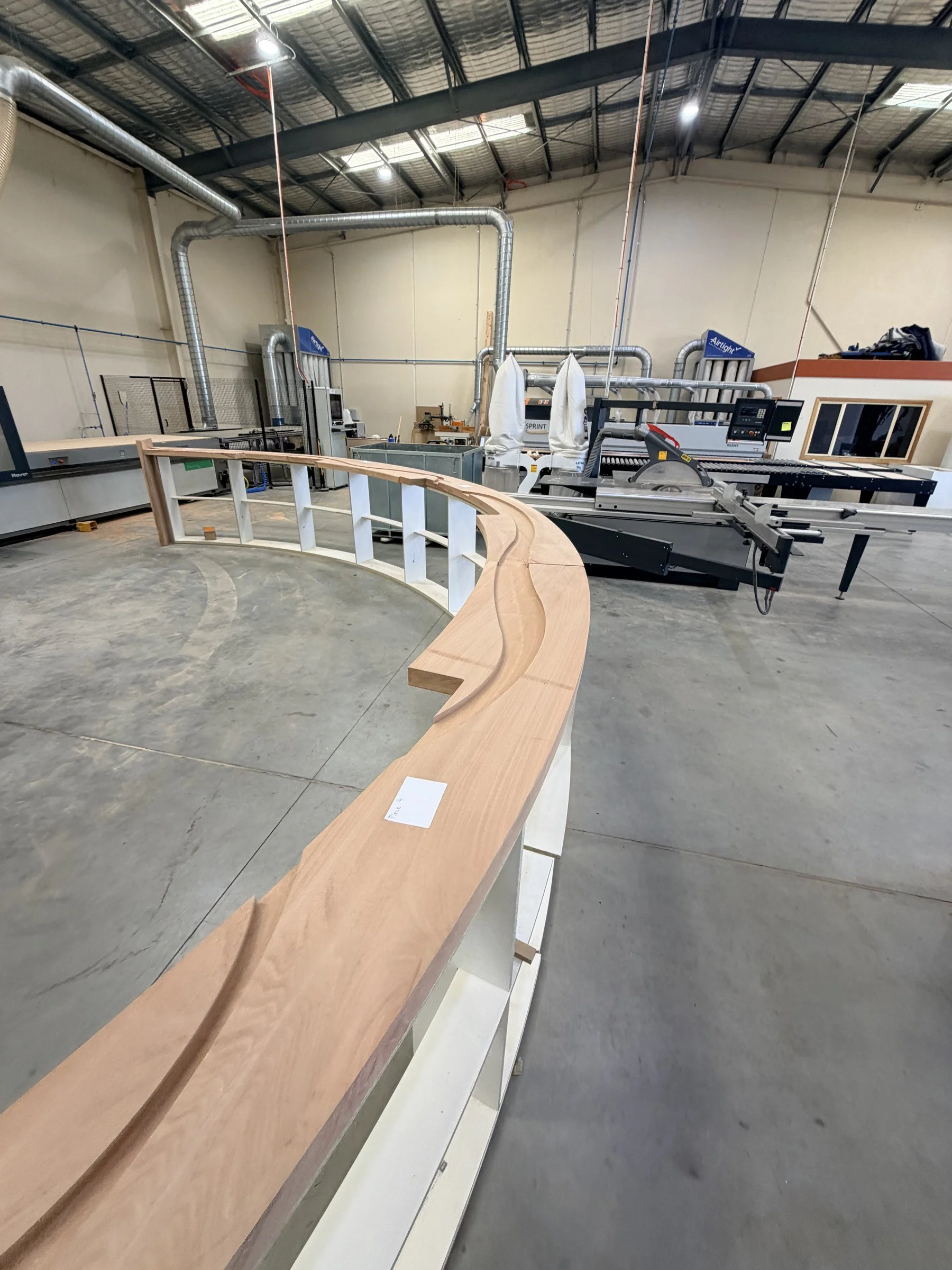 Step 3: a curved bartop section after machining, with the channel for the resin river routed along its length.