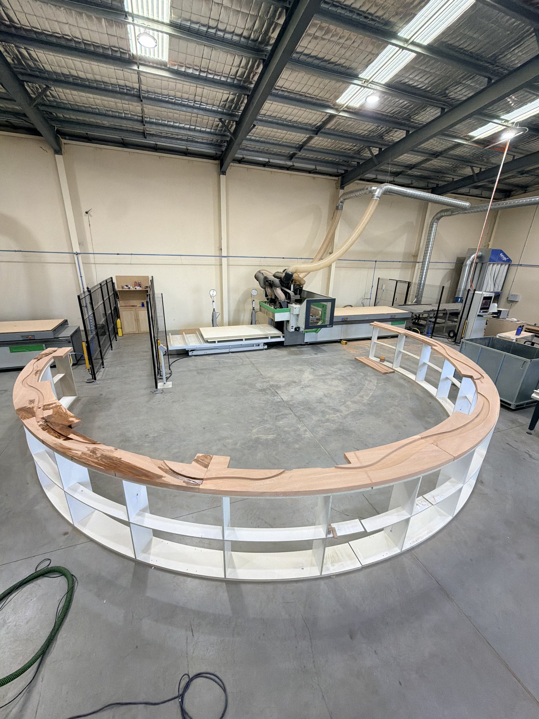Step 4: the curved bartop sections dry-fitted into a full ring on supports in the workshop to check the joins before the resin pour.