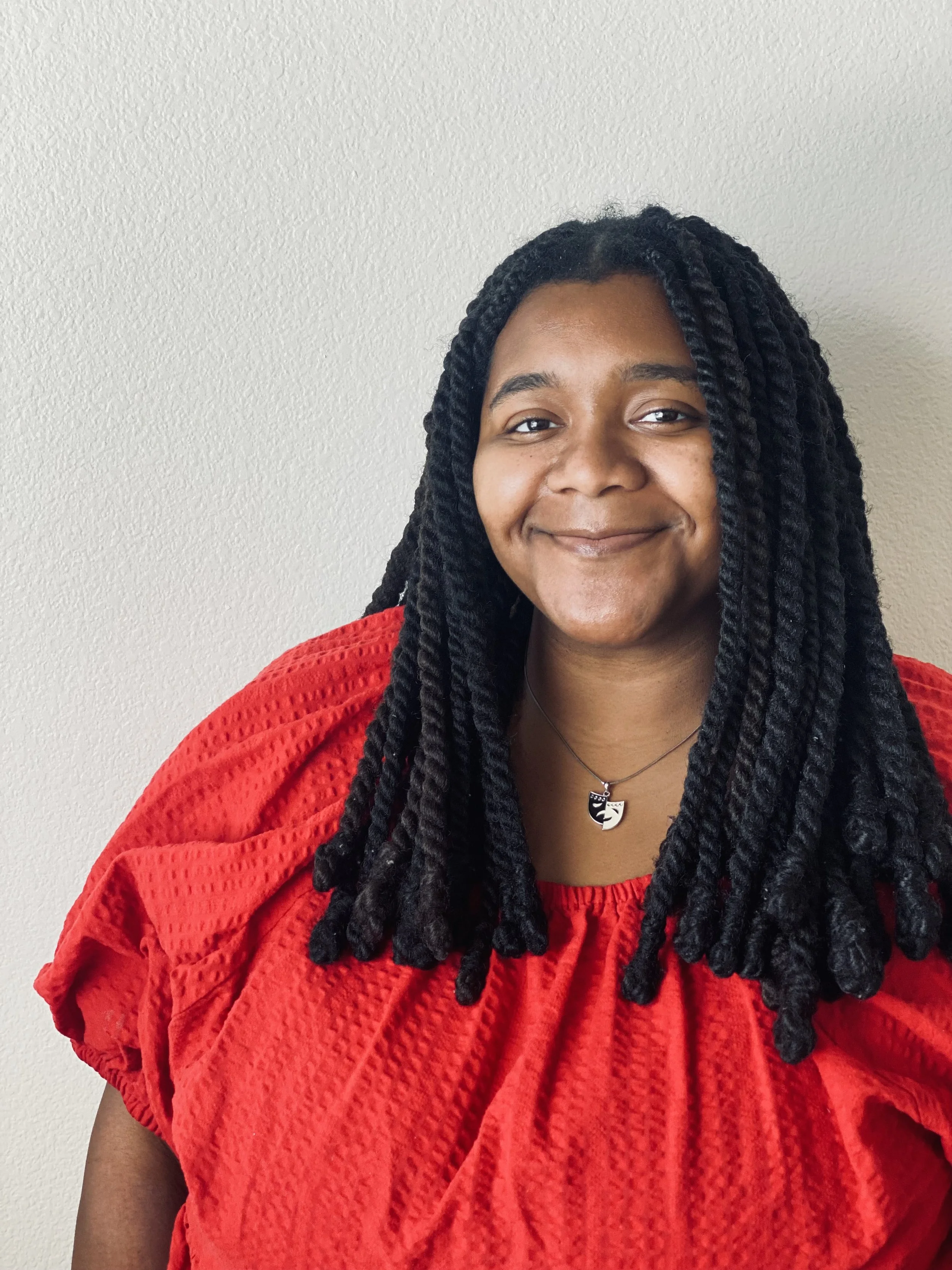 Close up portrait of Trinity Perry smiling.