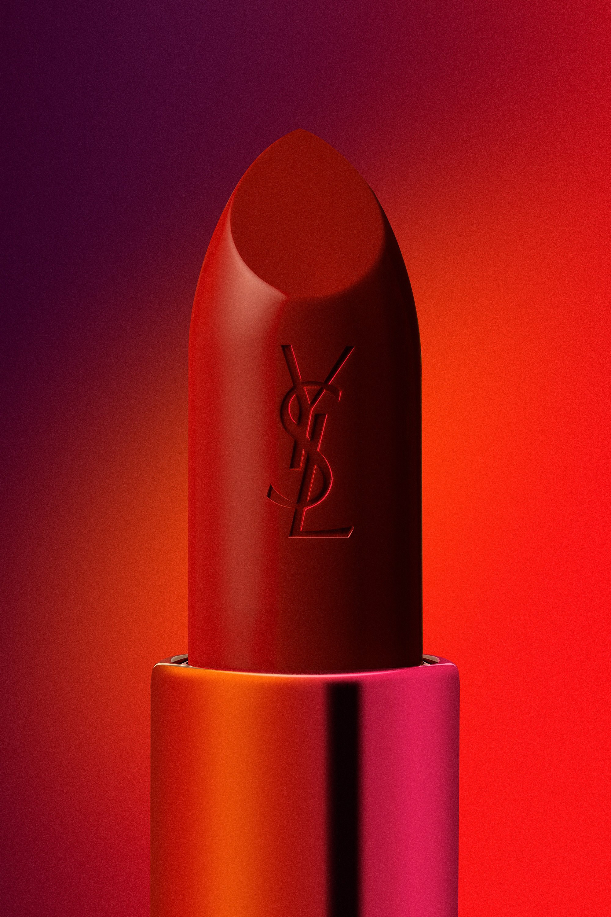 Un flacon de parfum de la marque Yves Saint Laurent, en forme d'obus, avec un logo YSL, dans un décor rouge et orange lumineux.