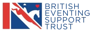 Logo of British Evening Support Trust featuring a stylized figure, a heart, and the organization's name.