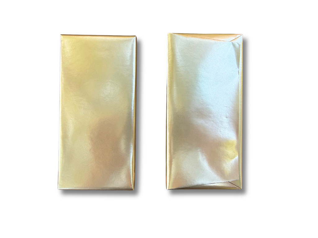 Two chocolate bars wrapped in shiny gold paper in a single layer packaging style with a Lareka BTB25 positioned on a white background.