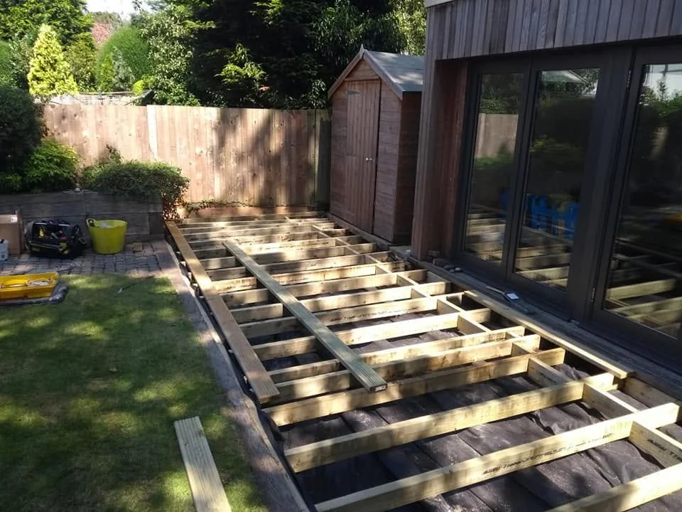 Replacement timber deck framework outside a garden room, before the surface boards are fitted.