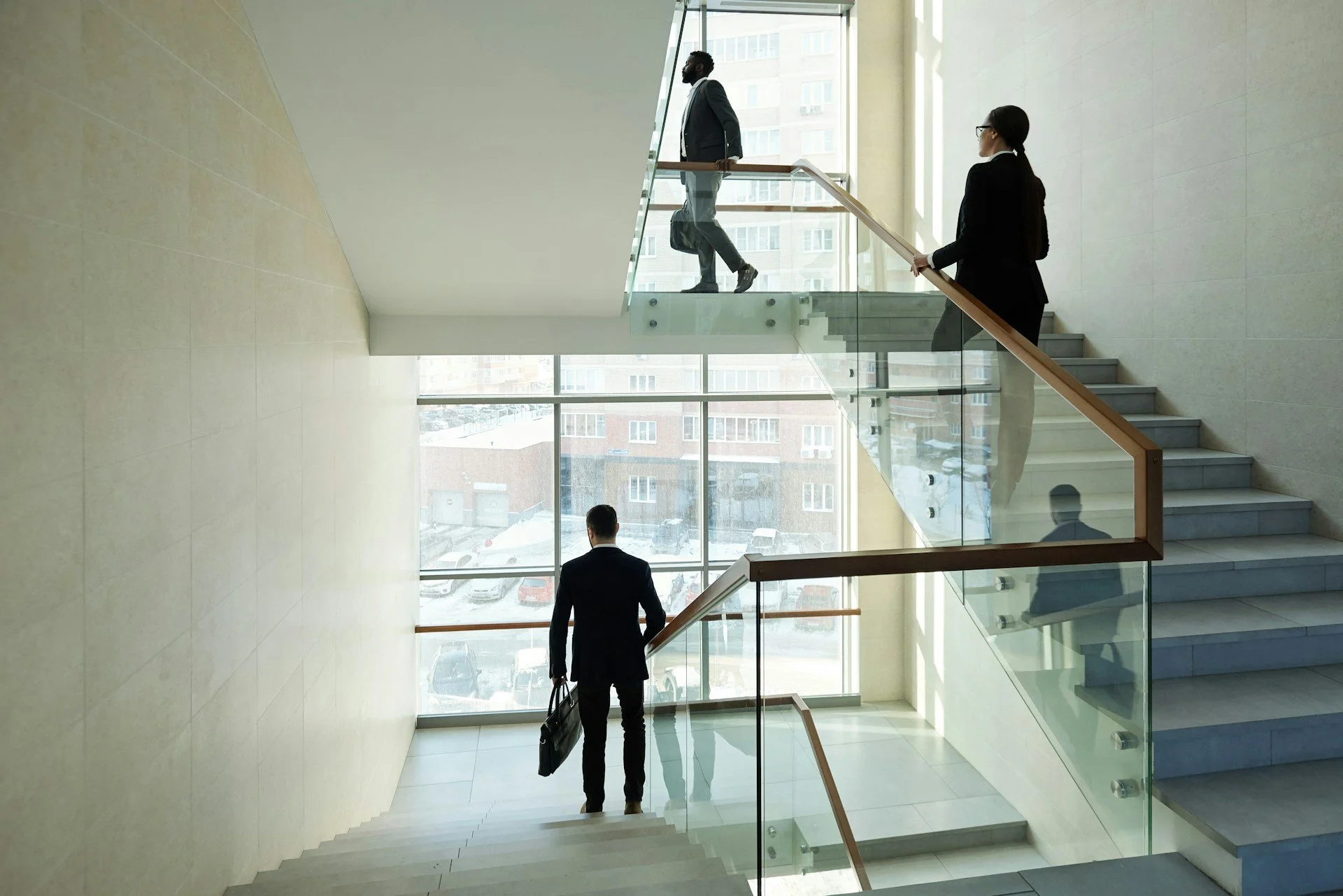 Employees walking in stairwell of Saas office