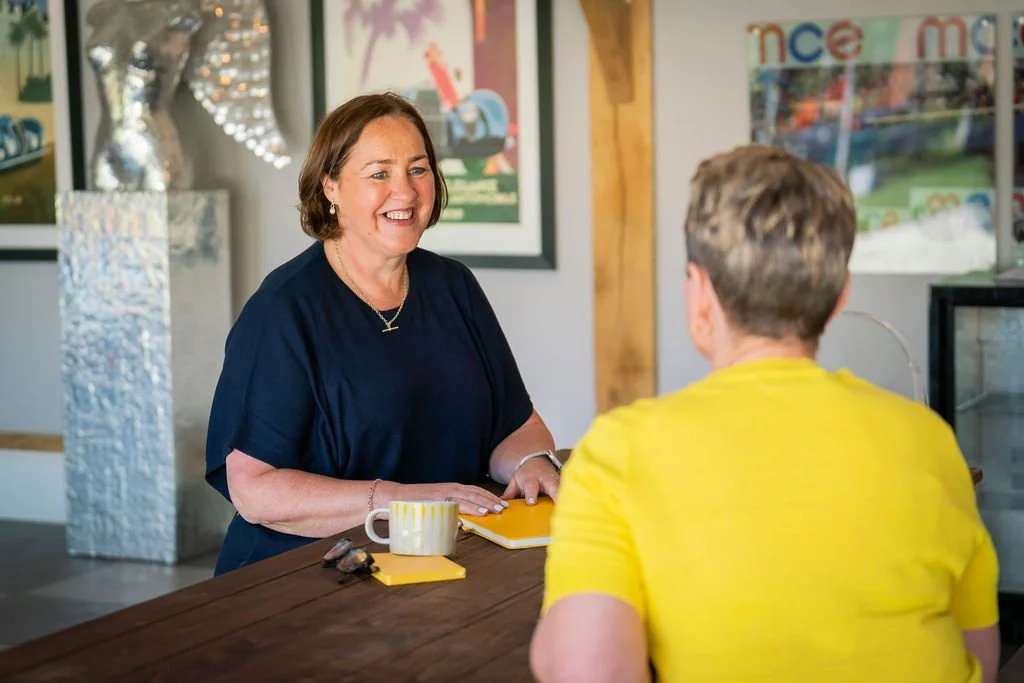 SaaS recruitment specialist sitting at desk with tech employer