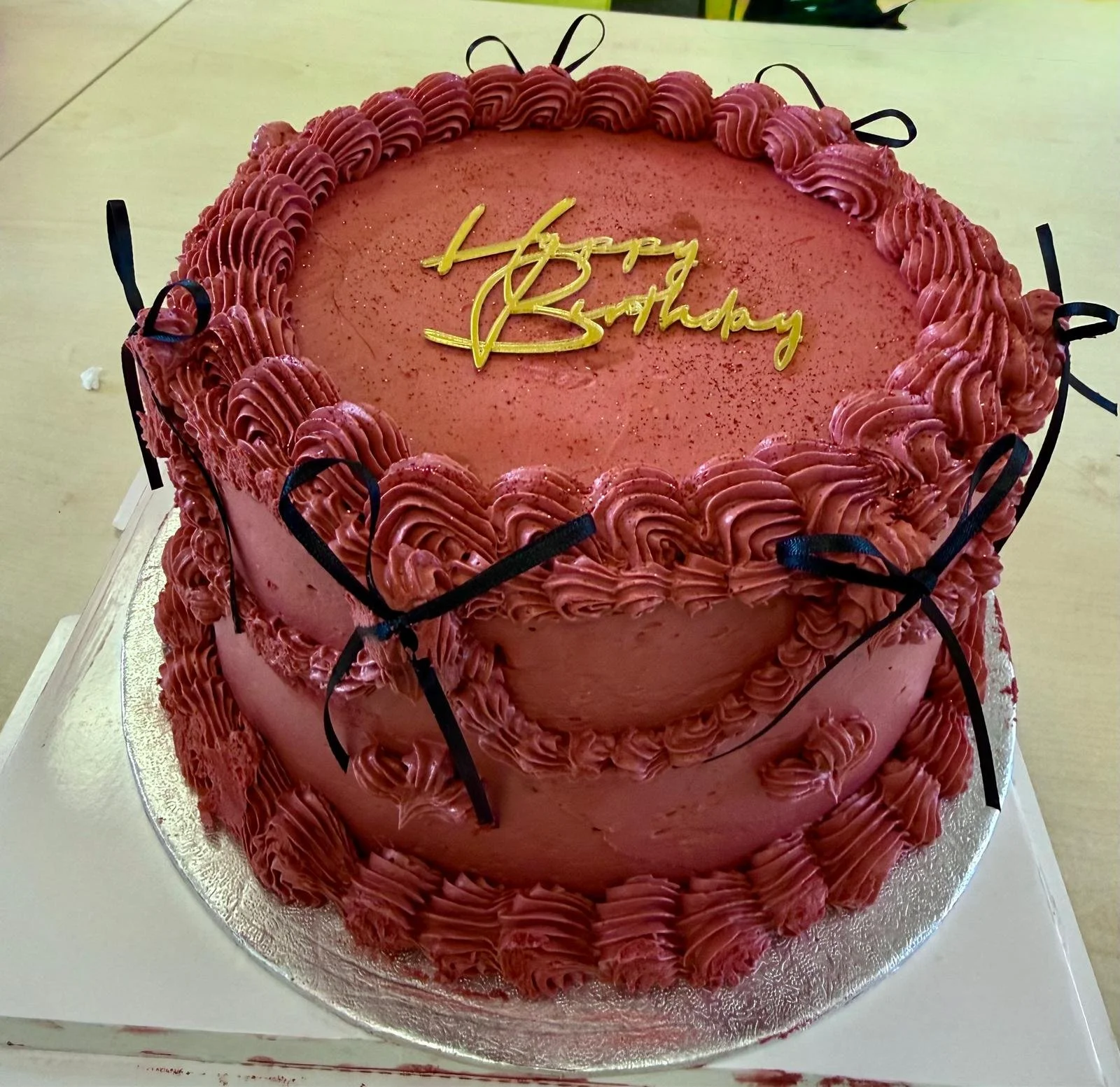 Pink vintage-style piped buttercream cake with bows