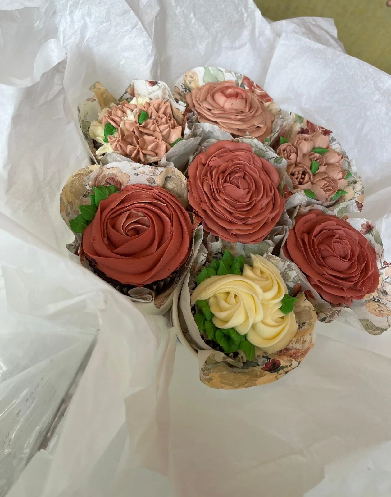 Box of buttercream rose bouquet cupcakes in pink and cream