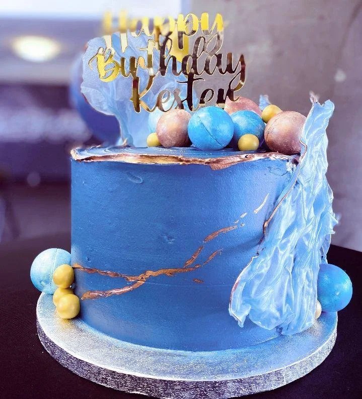 Blue marble buttercream celebration cake with chocolate sails