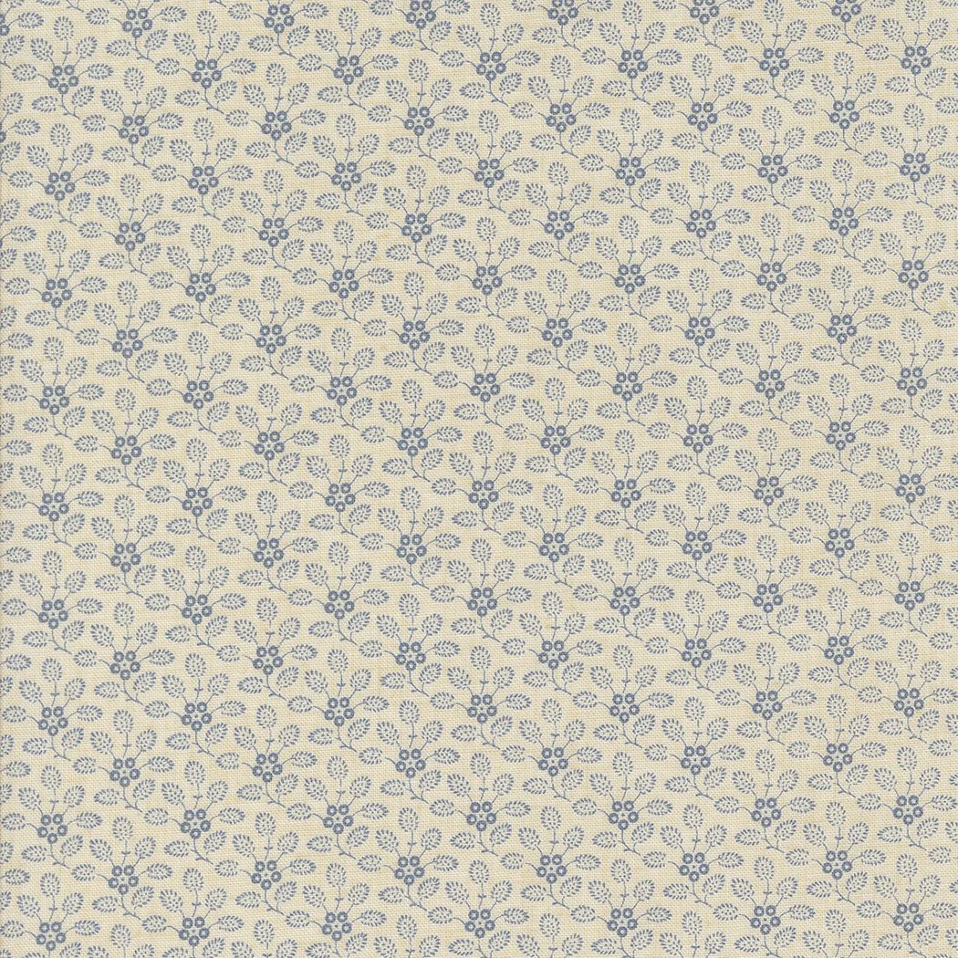 A pattern of small blue holly branches with berries on a light beige background.