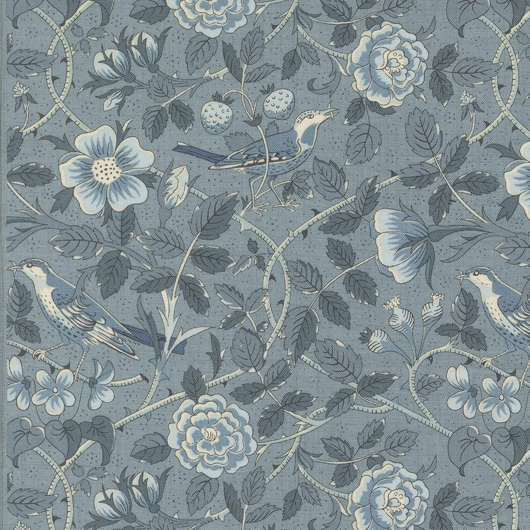 A floral patterned fabric with blue and beige flowers, green leaves, and small birds, set against a blue background.