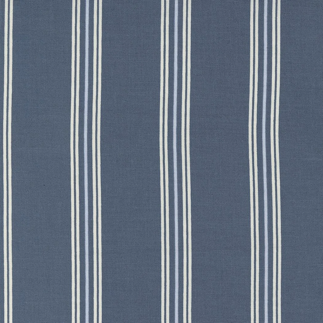 Close-up of blue fabric with white vertical stripes.
