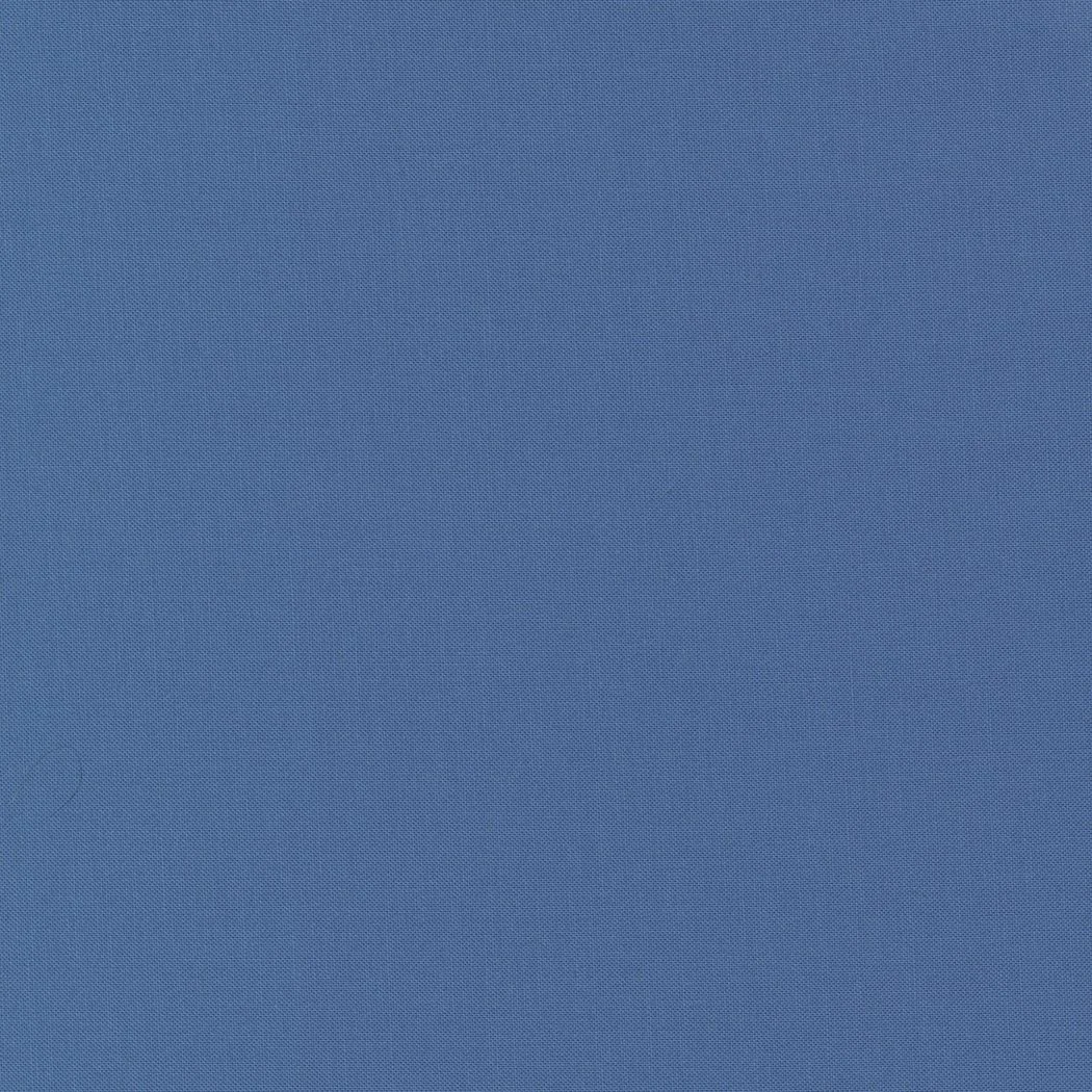 Solid blue fabric surface with a textured pattern.