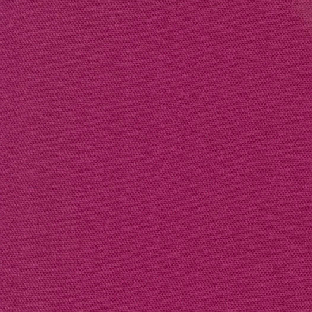 A textured pink fabric surface.