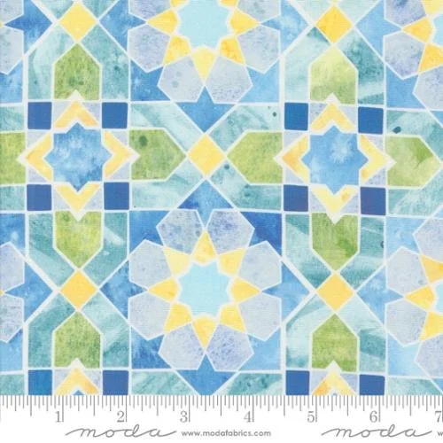 Close-up of colorful mosaic tile pattern with geometric shapes in blue, green, yellow, and white.