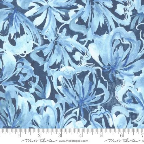 Pattern of blue and white hibiscus flowers on fabric with a ruler at the bottom showing inches.