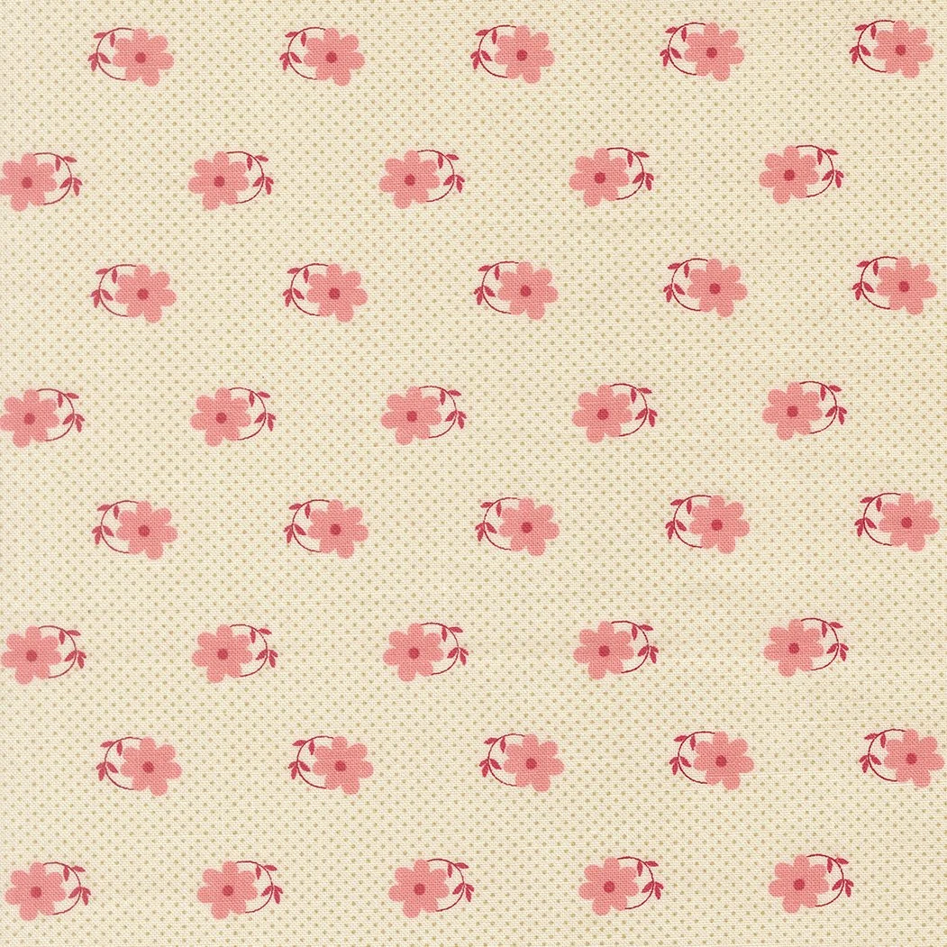 A fabric pattern with small pink flowers and green dots on a beige background.