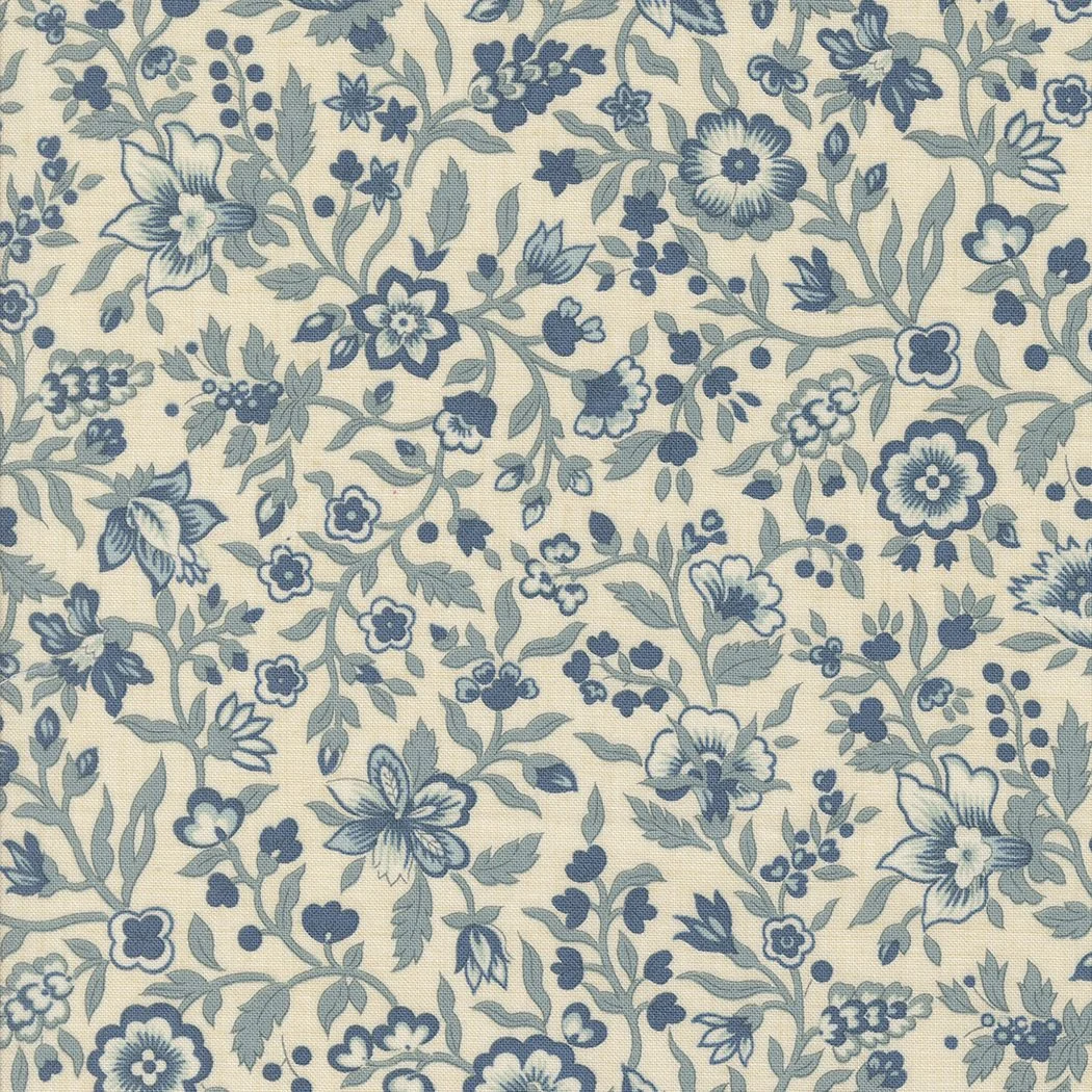 A fabric with a repeating floral pattern in blue and white, featuring various flowers, leaves, and a butterfly.