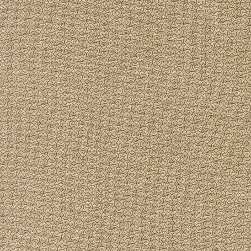 Close-up of a beige fabric with a small, repeating geometric pattern.