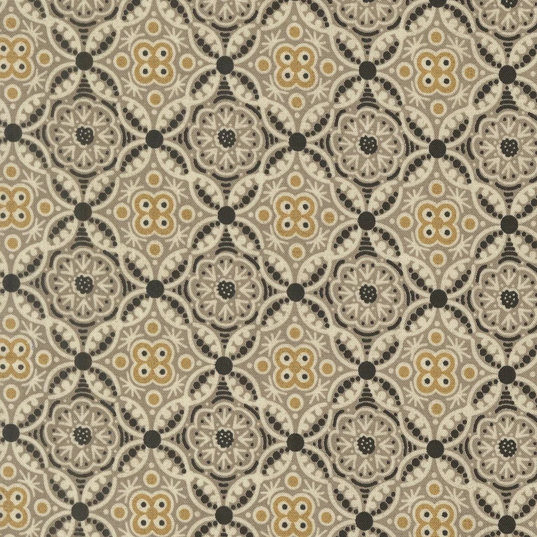 A patterned tile floor with intricate black, white, and beige designs featuring floral and geometric motifs.