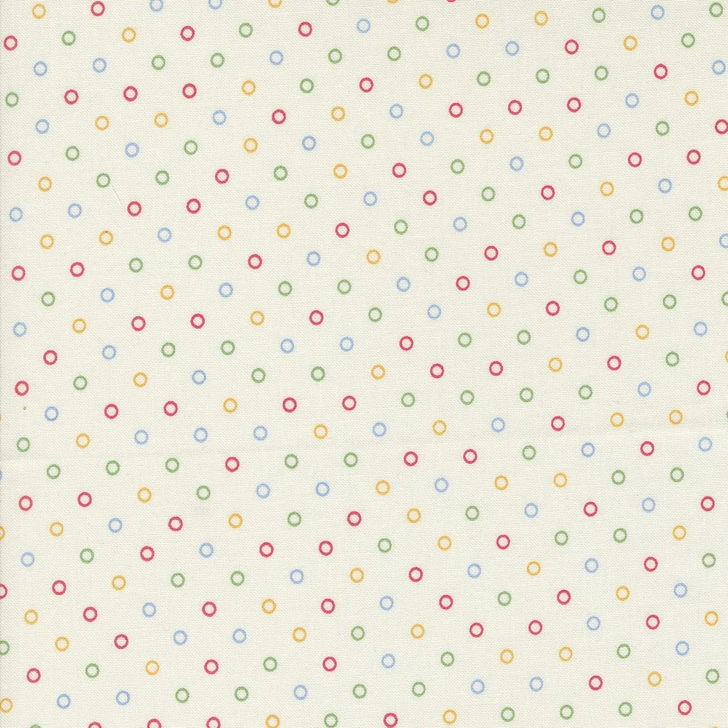 Pattern of small, colorful circles in red, blue, green, and yellow on a white background.