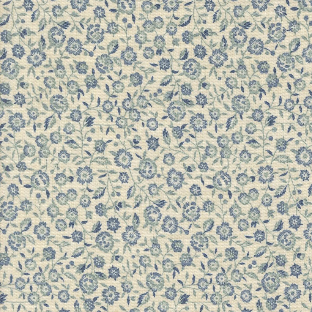 Close-up of fabric with a dense pattern of small blue flowers and green leaves on a light background.
