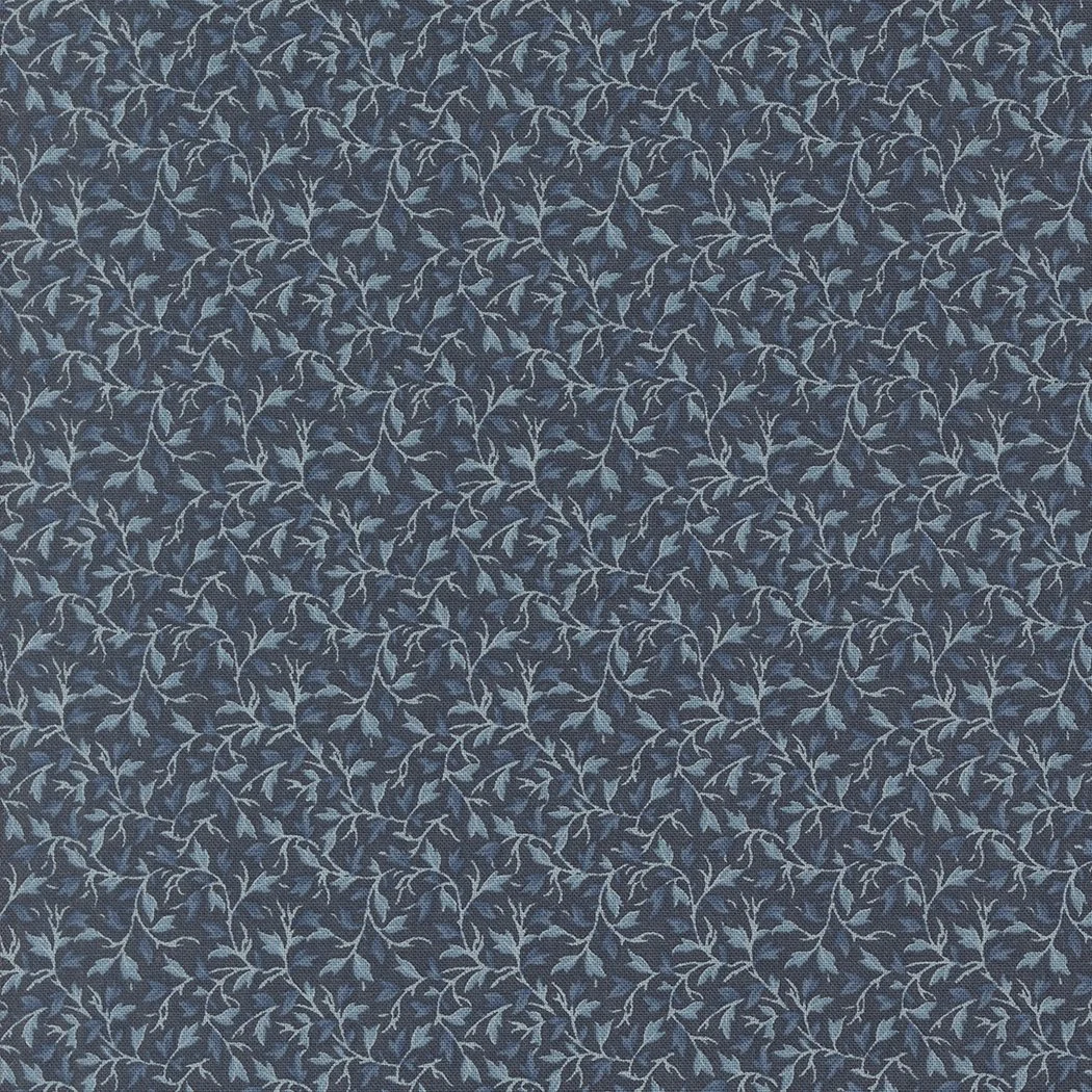 Close-up of fabric with a dark background and a pattern of light blue leaves and vines.