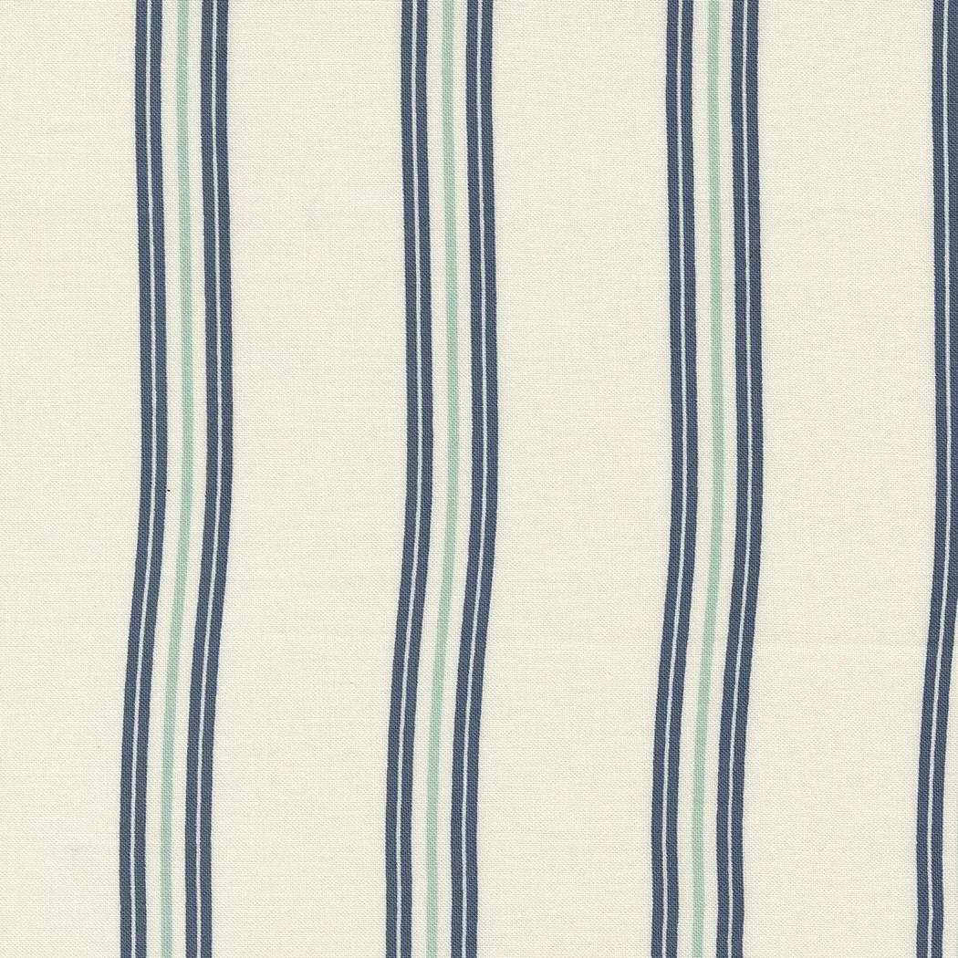 Close-up of fabric with vertical stripes in navy blue, light blue, and light green on a cream background.