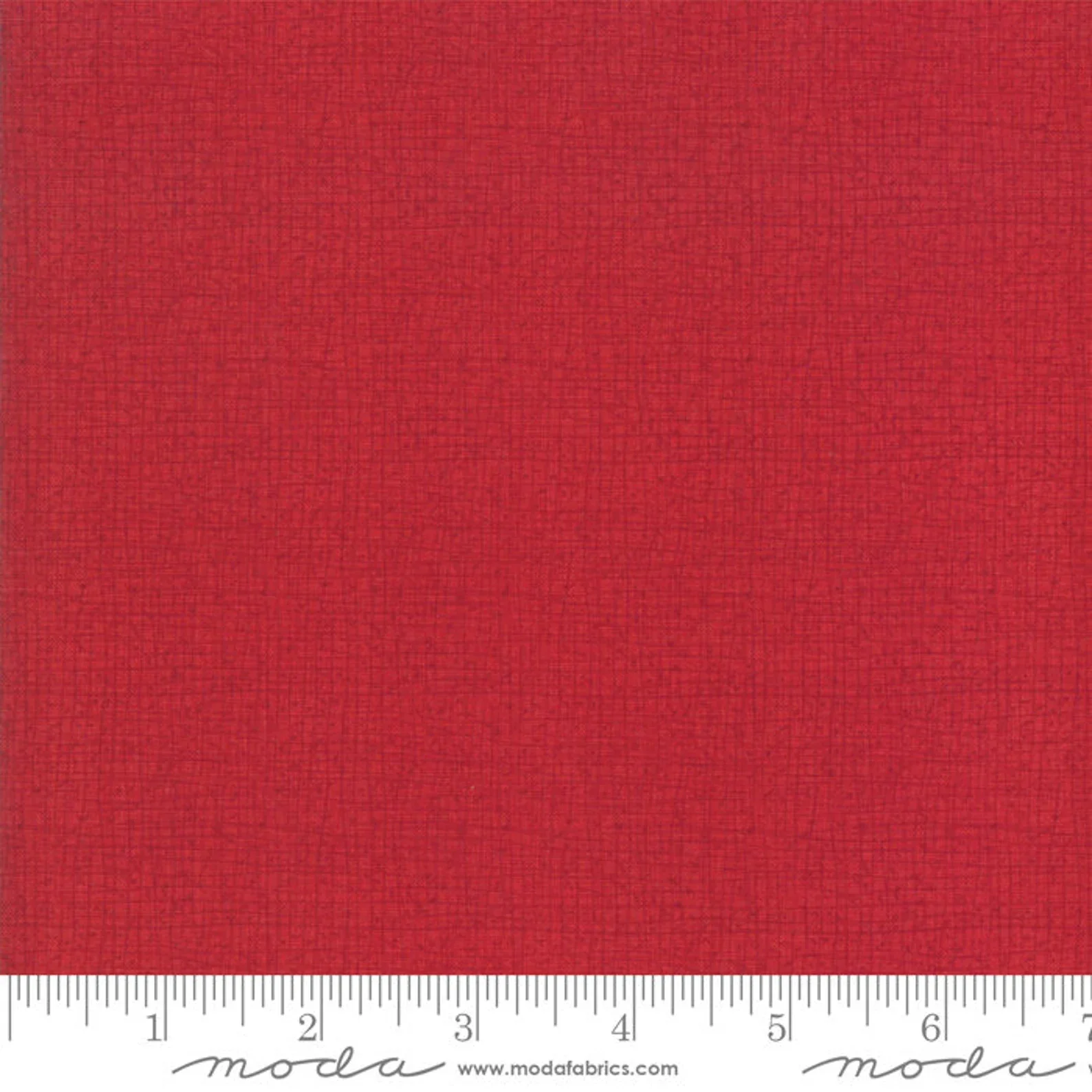 Close-up of red fabric with a subtle woven texture