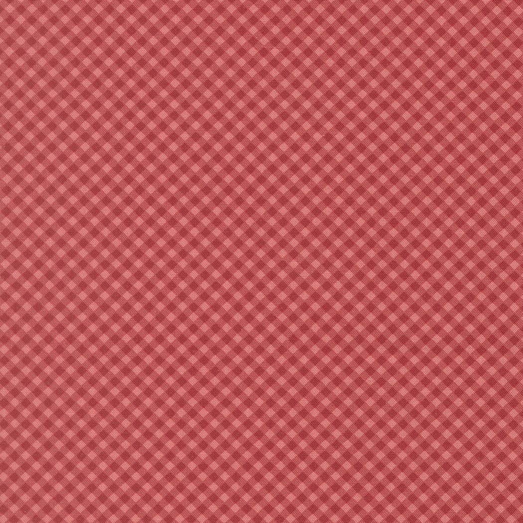 Red checkered fabric background with small white and pink diamond shapes.