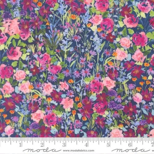 Colorful floral fabric with pink, purple, yellow, and green flowers and plants, with a ruler at the bottom.