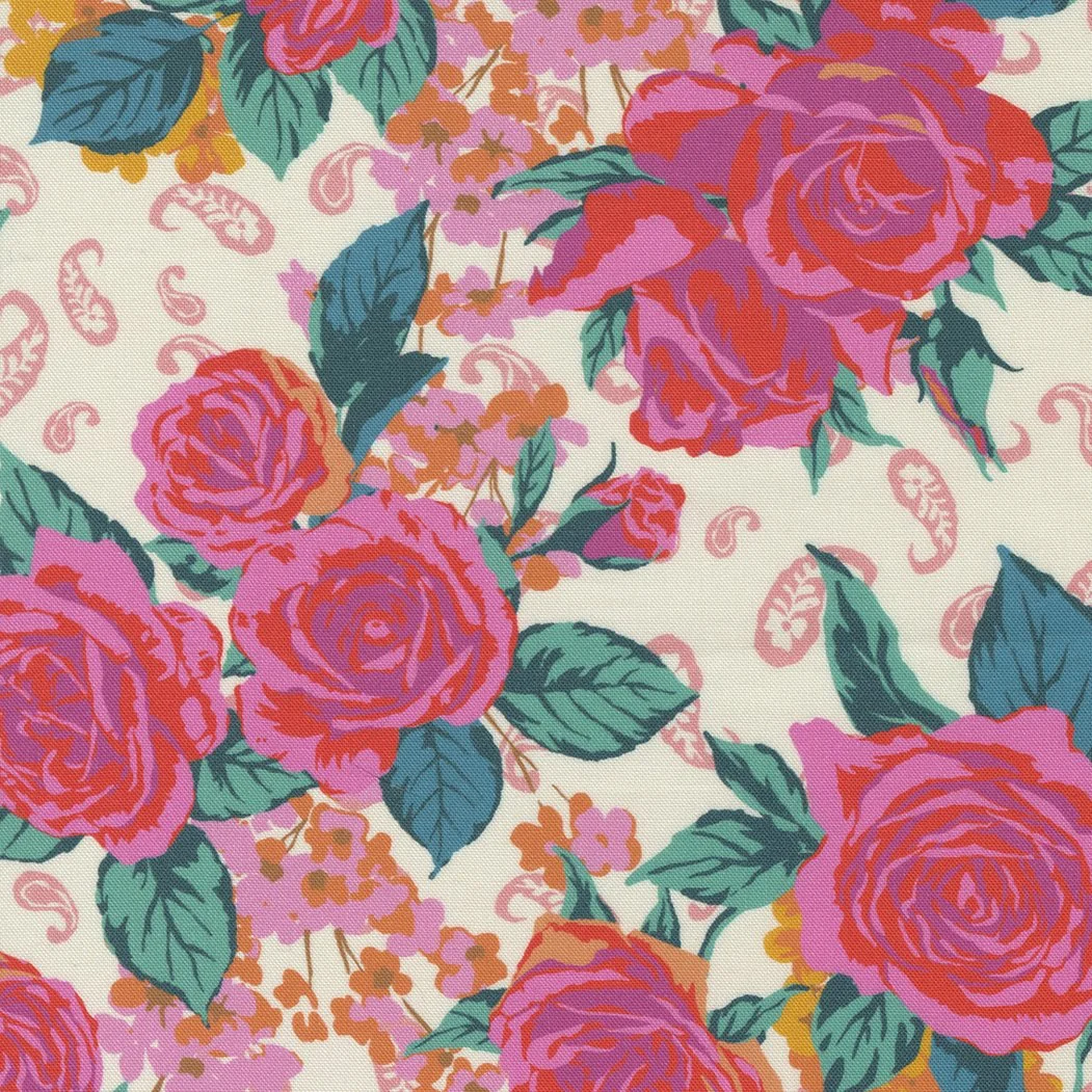 A vibrant floral pattern featuring pink and purple roses with green leaves on a cream background.