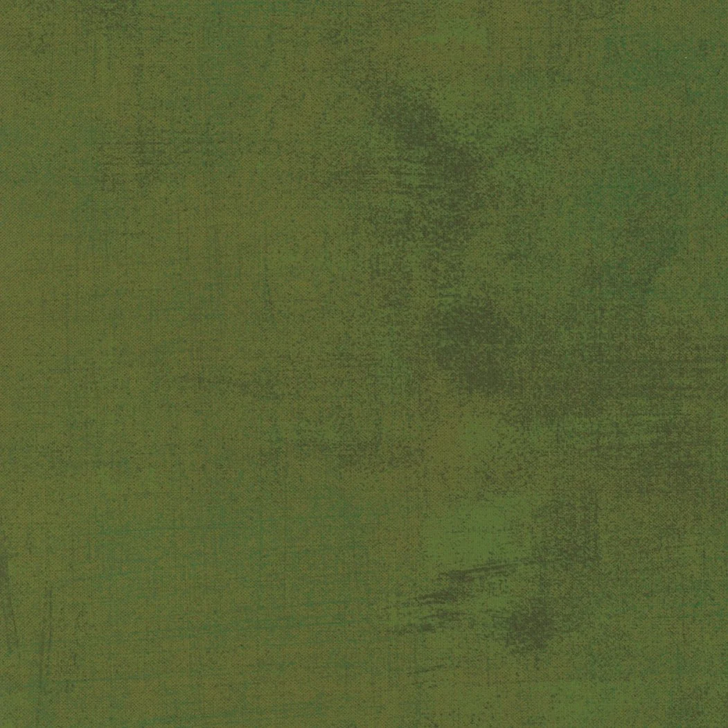 Close-up of a green wooden surface with visible grain and texture.