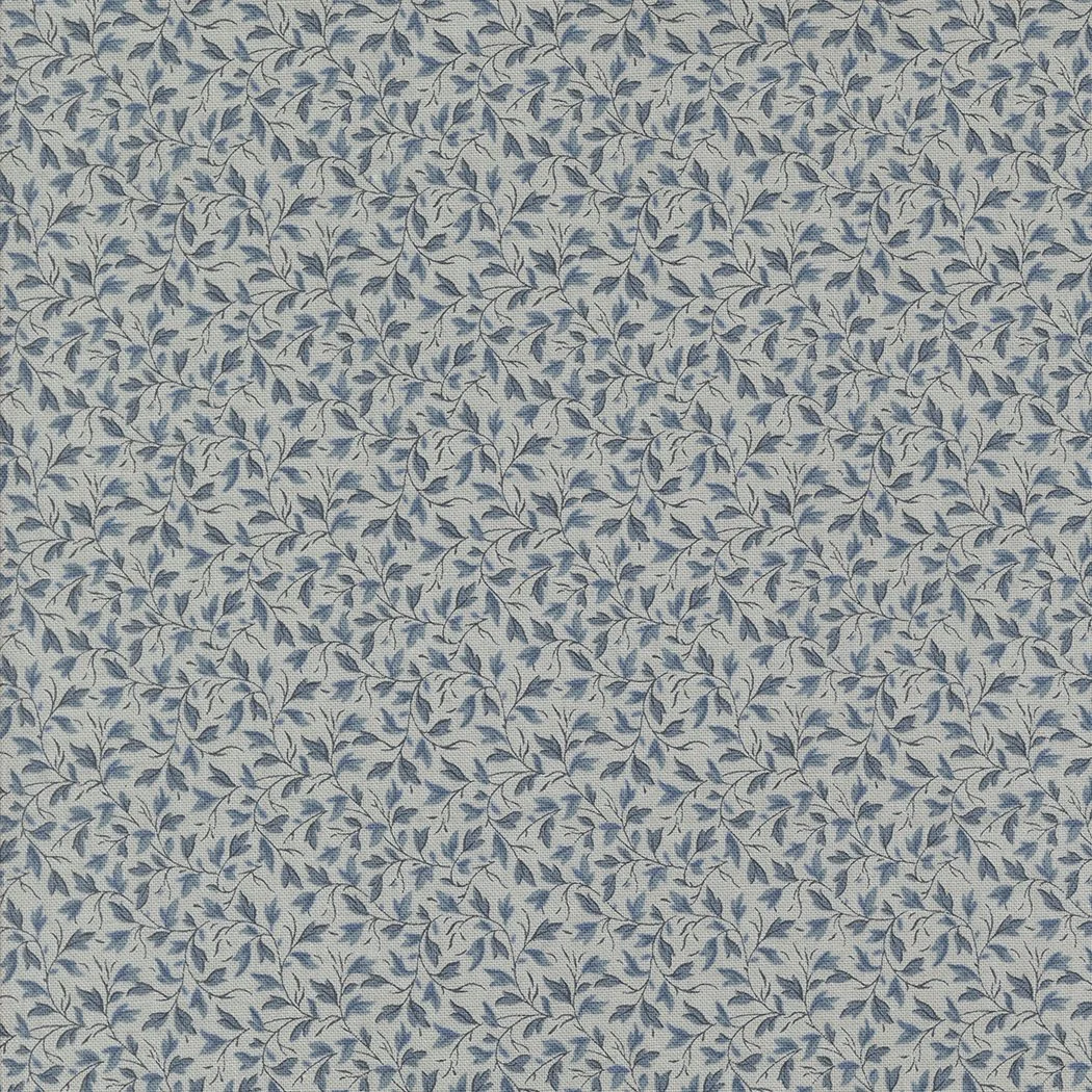 Close-up of fabric with a pattern of small, dark blue leaves on a light background