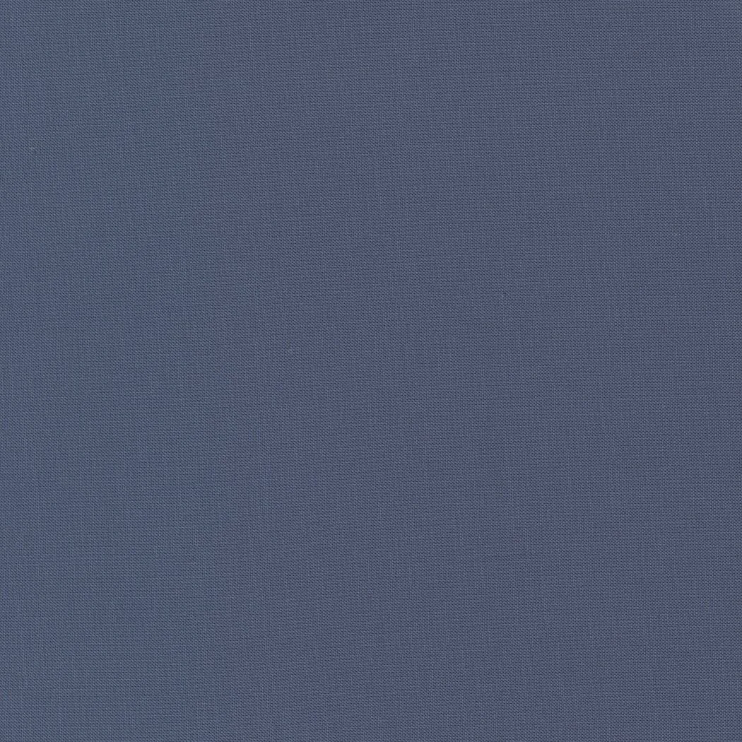 A close-up of a blue fabric with a textured, woven pattern.